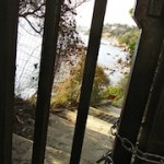 "Padlocked gate preventing continuation to the hiking trail in the Sentier Littoral"