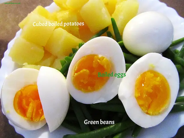 "Cubed boiled potatoes, boiled eggs and string beans"