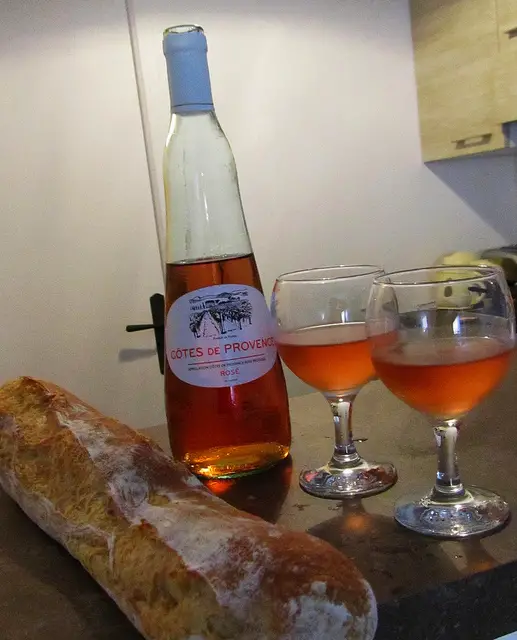 "A chilled bottle of Rose and a fresh baguette with salad nicoise"