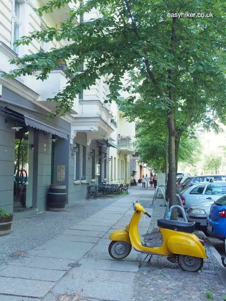 "old vespa on a tree lined street - spirit of Bohemian Berlin"