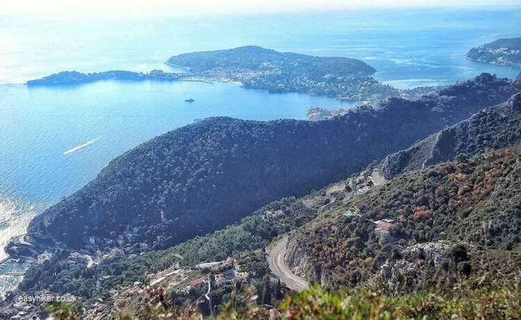 "The vista of the French Riviera - Eze Hiker Conquering the Peak in the Sequel