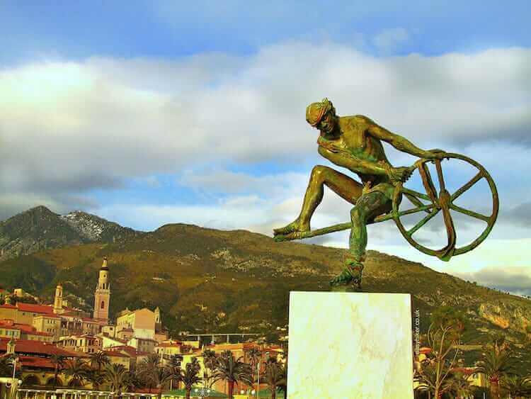 "the steep hills of Menton seen from the seaside""