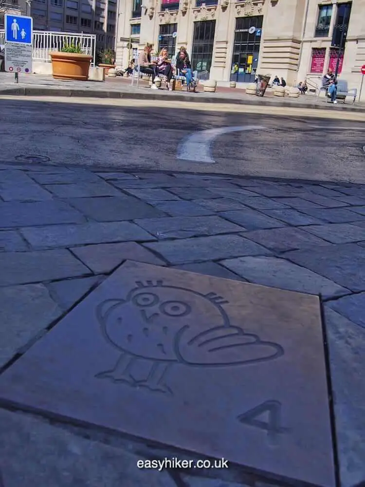 "with these signs, you can Follow the Owl on a Walk Through Dijon"