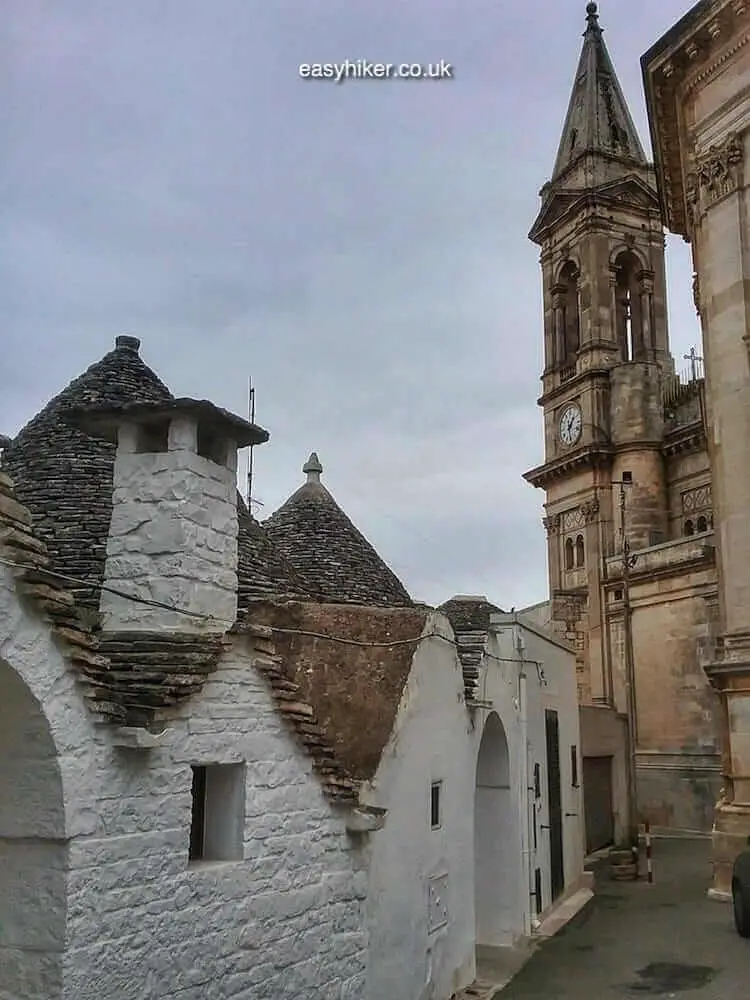 "some old trullo by a church on A Visit to the Trullo Town of Alberobello"